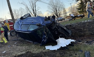 Car Snaps Utility Pole and Rolls Over