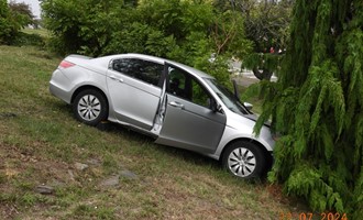 Vehicle down hill strikes tree
