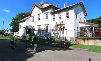 Firefighters respond to fireworks-triggered structure fire in historic Farnum House