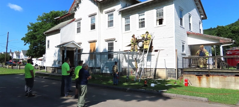 Firefighters respond to fireworks-triggered structure fire in historic Farnum House